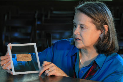 Prof. Karen King holds up the fragment known as the 'Gospel of Jesus' wife', which she brought to public notice.